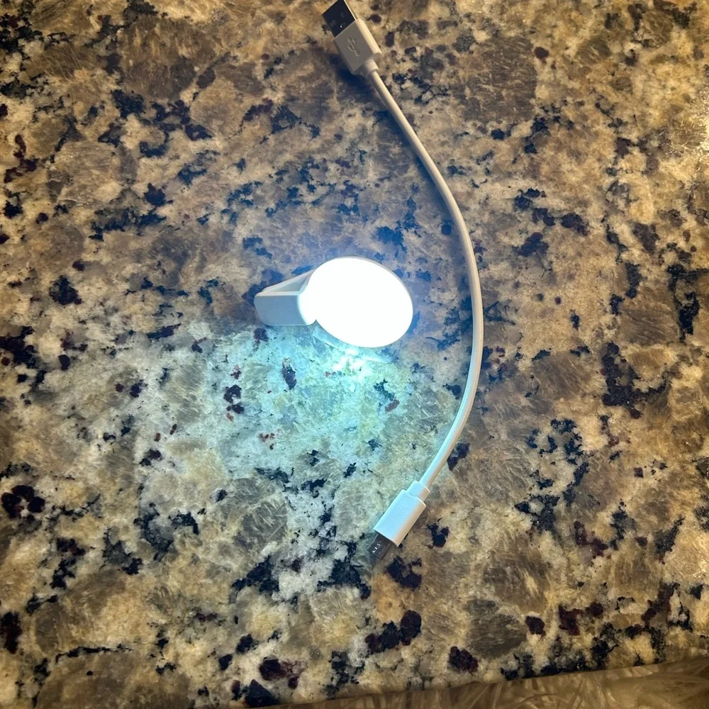 White Mini phone light with clip and  Charging Cable
